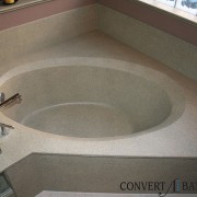Faux granite on cultured marble with frameless shower door